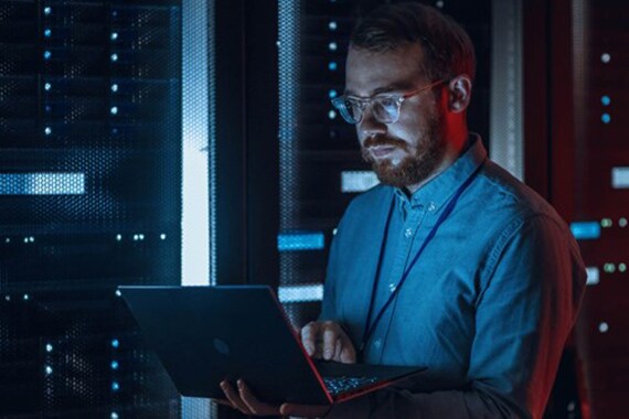 Image of worker in a server room.